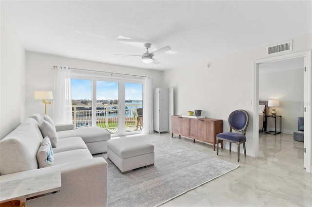 living room with ceiling fan, visible vents, and baseboards