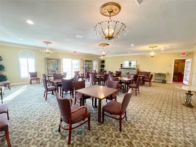 carpeted dining room with ornamental molding and a notable chandelier