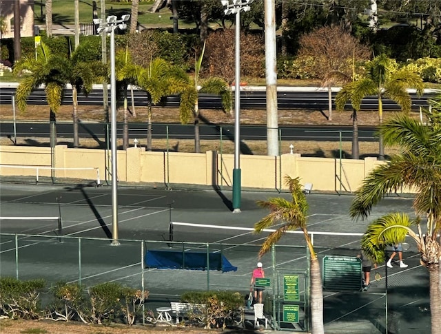 view of tennis court with fence