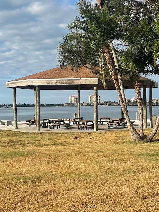 surrounding community with a water view, a yard, and a gazebo