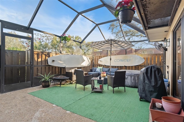 view of patio featuring a lanai, an outdoor living space with a fire pit, and fence