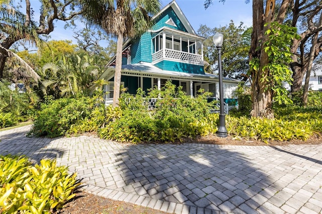 rear view of property with a sunroom