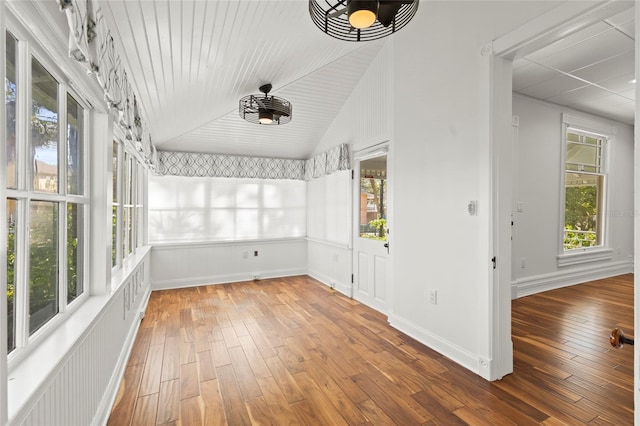 unfurnished sunroom featuring vaulted ceiling