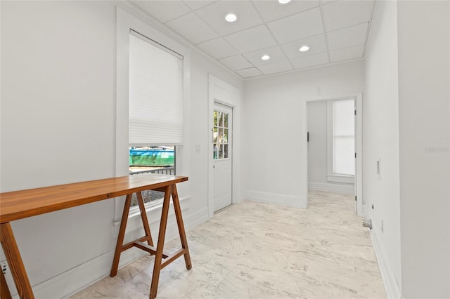 hall featuring baseboards, marble finish floor, a drop ceiling, and recessed lighting