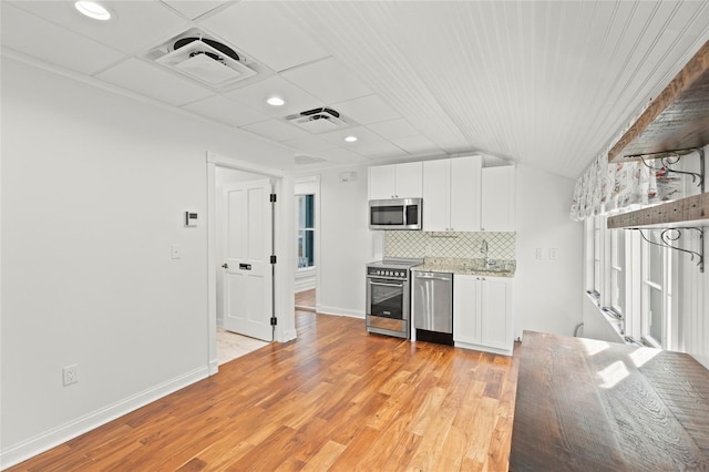 kitchen featuring open shelves, visible vents, backsplash, appliances with stainless steel finishes, and white cabinetry