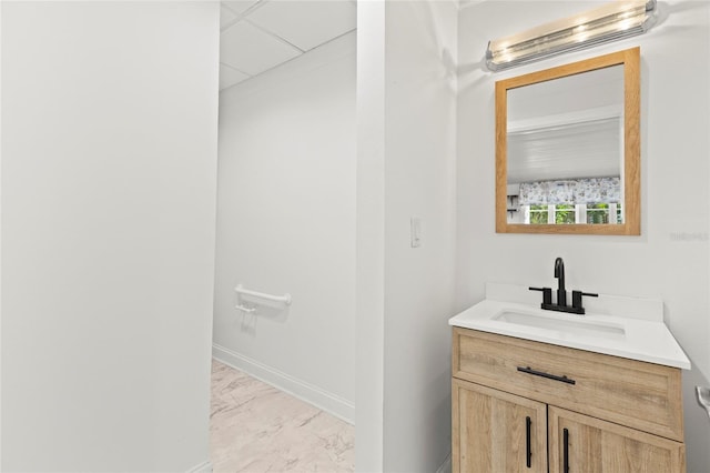 bathroom with marble finish floor, baseboards, and vanity