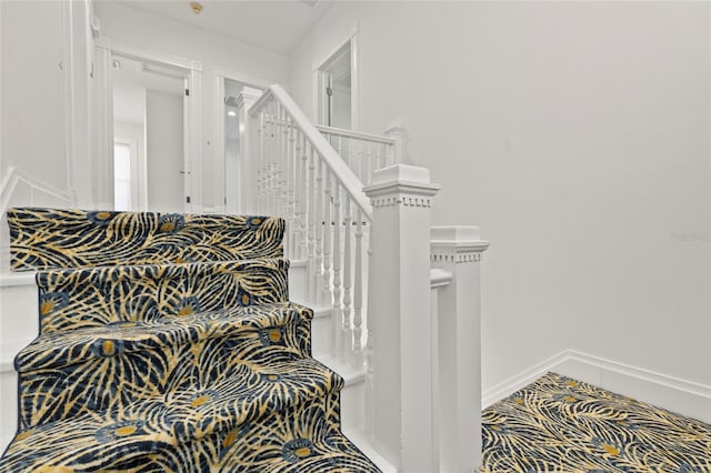 staircase featuring baseboards