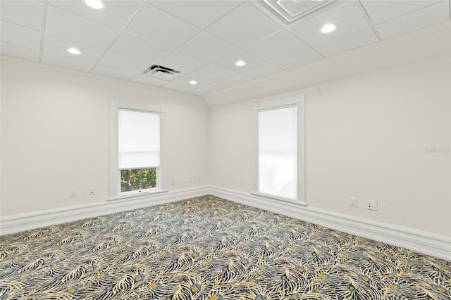 carpeted empty room with a paneled ceiling, baseboards, visible vents, and recessed lighting