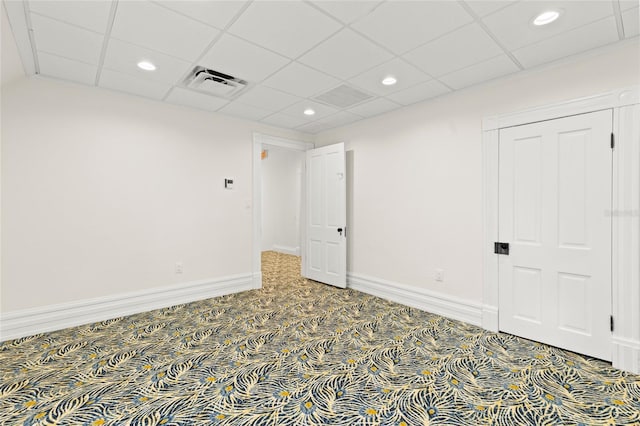 unfurnished room with baseboards, visible vents, carpet, a paneled ceiling, and recessed lighting