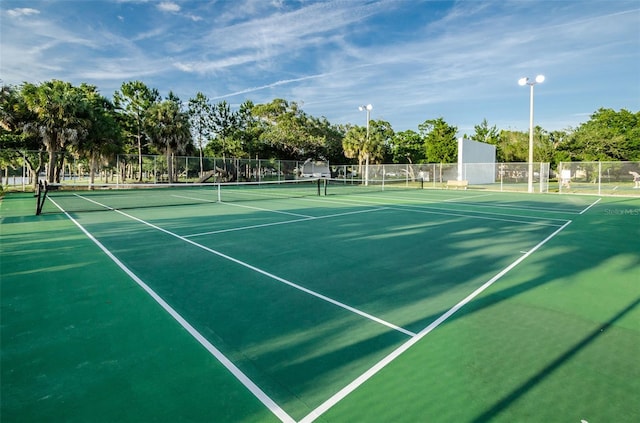 view of tennis court with fence