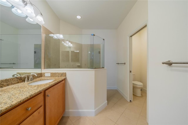 bathroom featuring toilet, a stall shower, tile patterned flooring, and vanity