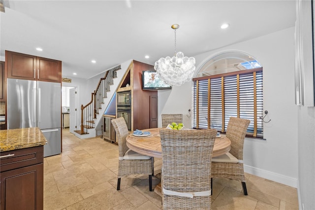 dining space featuring stone tile flooring, recessed lighting, and stairs