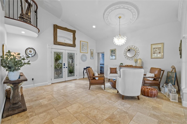 sitting room with stone tile flooring, french doors, baseboards, and high vaulted ceiling