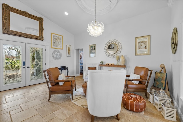 sitting room featuring a chandelier, vaulted ceiling, recessed lighting, french doors, and stone tile flooring