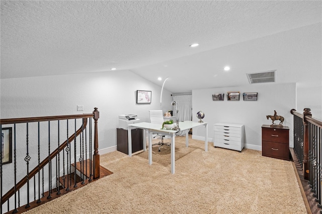 carpeted office space with lofted ceiling, baseboards, visible vents, and a textured ceiling