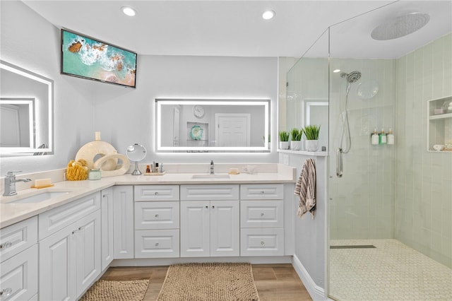 full bathroom with a sink, double vanity, and a walk in shower