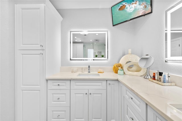 full bathroom featuring double vanity and a sink