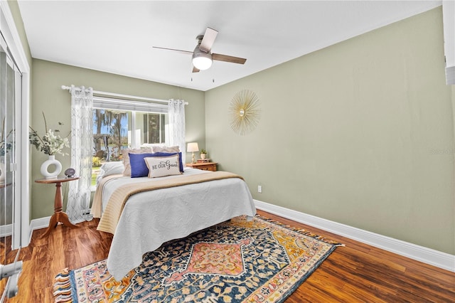 bedroom with wood finished floors and baseboards