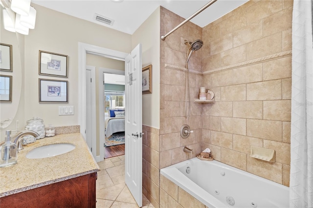 full bathroom featuring visible vents, connected bathroom, a combined bath / shower with jetted tub, tile patterned floors, and vanity