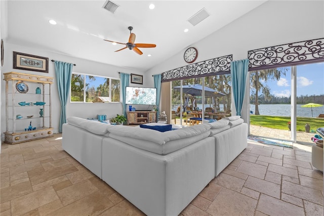 living room with recessed lighting, visible vents, lofted ceiling, and stone tile flooring