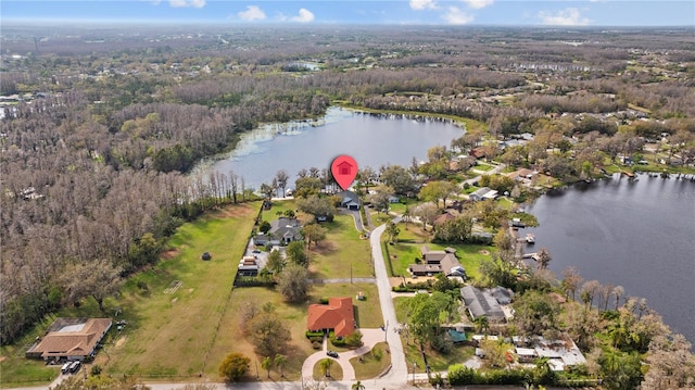 birds eye view of property featuring a view of trees and a water view