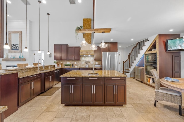 kitchen featuring stone tile floors, a sink, decorative backsplash, black appliances, and decorative light fixtures