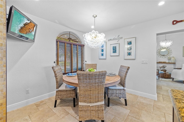 dining area featuring recessed lighting, baseboards, an inviting chandelier, and stone tile floors