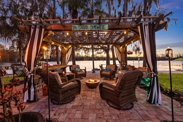 patio terrace at dusk with a water view, outdoor lounge area, and a pergola