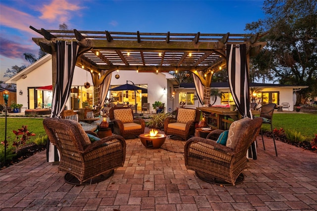 patio terrace at dusk featuring an outdoor living space with a fire pit and a pergola