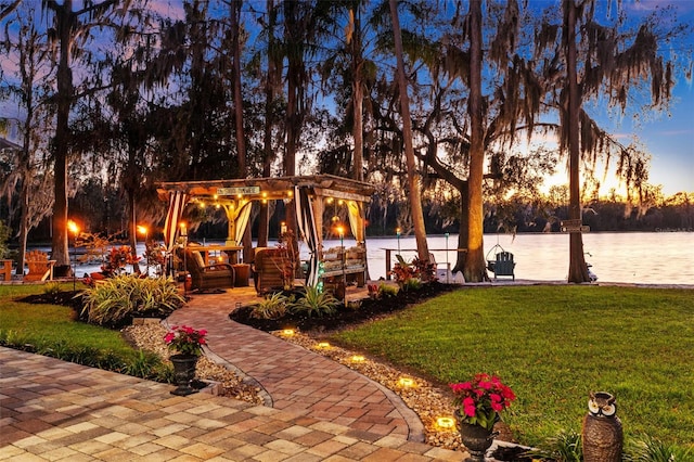 view of yard with a water view and a pergola