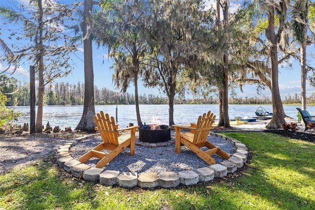 view of yard featuring an outdoor fire pit and a water view