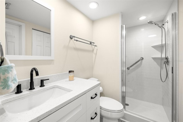 full bathroom with recessed lighting, a closet, toilet, a stall shower, and vanity