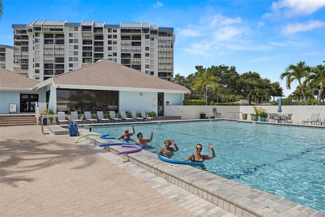 pool featuring a patio area and fence