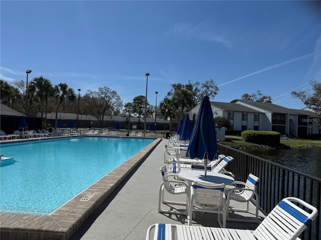 pool featuring a patio area and fence