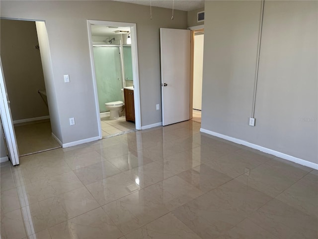 unfurnished bedroom featuring marble finish floor, visible vents, baseboards, and ensuite bathroom