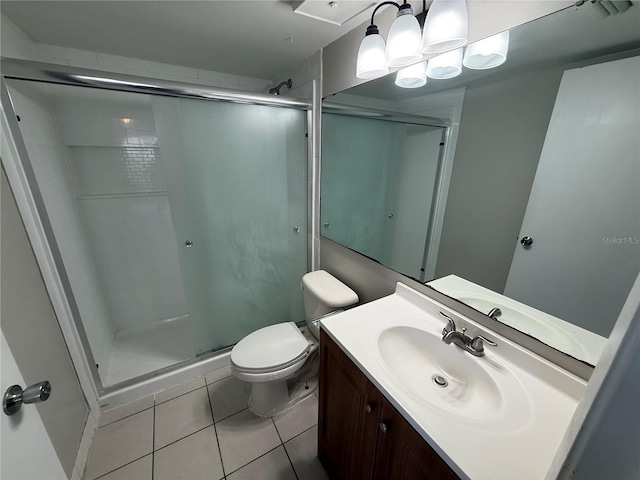 full bath with toilet, a stall shower, tile patterned flooring, and vanity