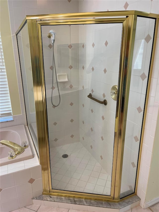 bathroom with a garden tub and a shower stall