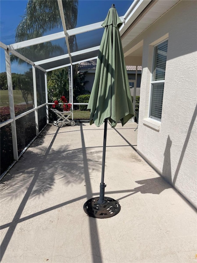 view of patio / terrace featuring a lanai