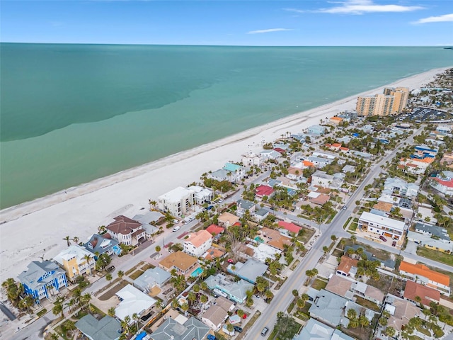 birds eye view of property featuring a water view, a residential view, and a view of the beach