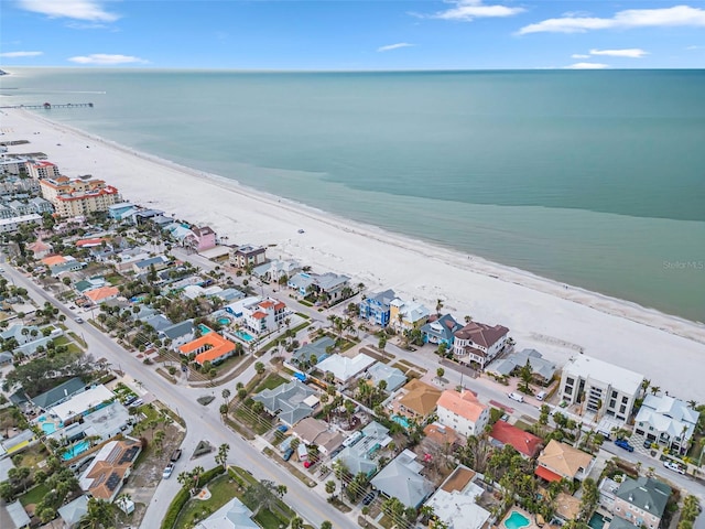 birds eye view of property with a water view, a residential view, and a beach view