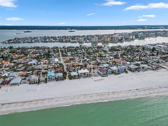 birds eye view of property with a water view and a view of the beach