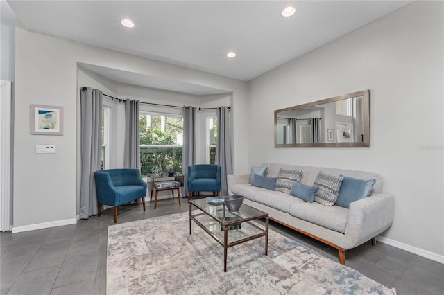 tiled living area with recessed lighting and baseboards