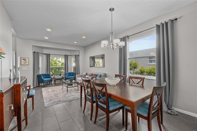 dining space with plenty of natural light, baseboards, a notable chandelier, and recessed lighting