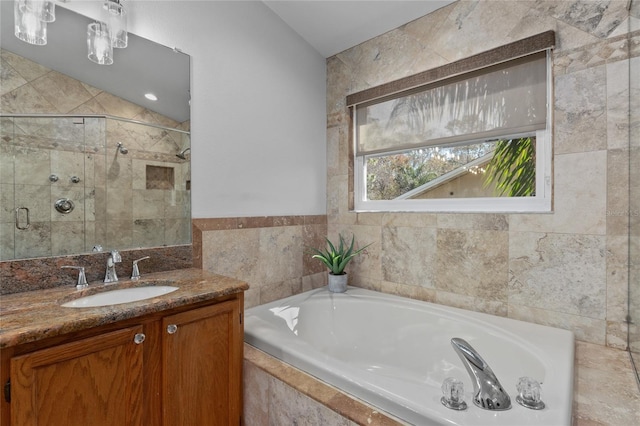 bathroom featuring a shower stall, vanity, and a bath