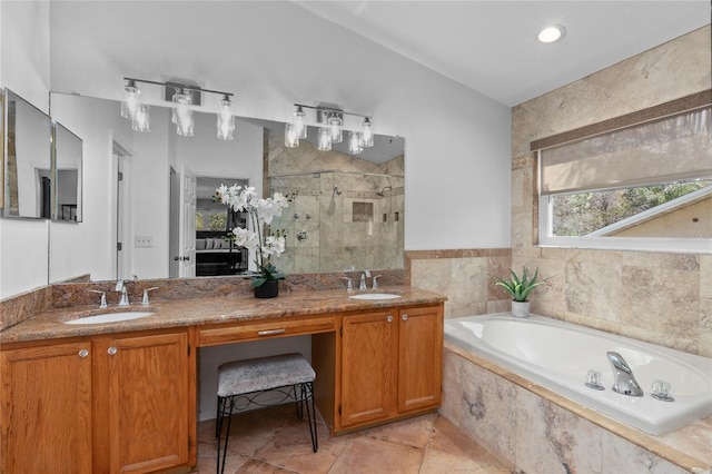 bathroom featuring a garden tub, a sink, a shower stall, and double vanity