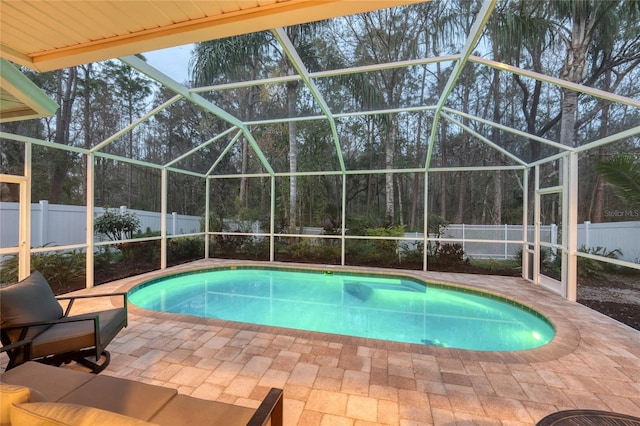 view of swimming pool featuring a patio area, a fenced backyard, a fenced in pool, and a lanai