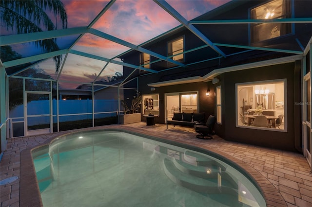 view of swimming pool with a patio area, a lanai, a fenced in pool, and fence