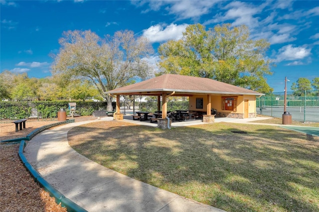 view of property's community featuring a patio area, fence, a gazebo, and a lawn