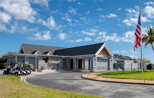 view of building exterior with driveway and an attached garage