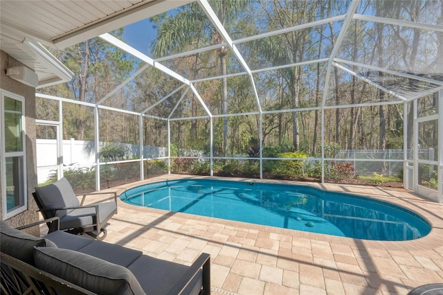 view of swimming pool with a patio, a fenced backyard, a fenced in pool, and a lanai